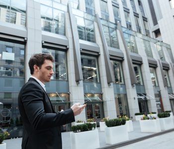 Man in big center using smartphone
